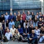 AI science funding - Scientists working with AI technology in a modern research laboratory