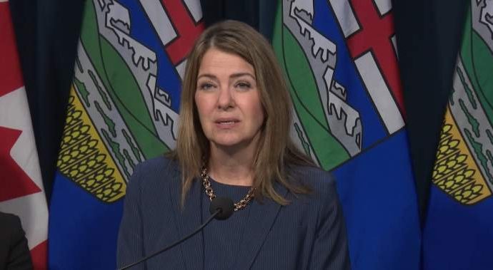Alberta immigration address - Alberta Premier Danielle Smith speaking at a podium during a government announcement