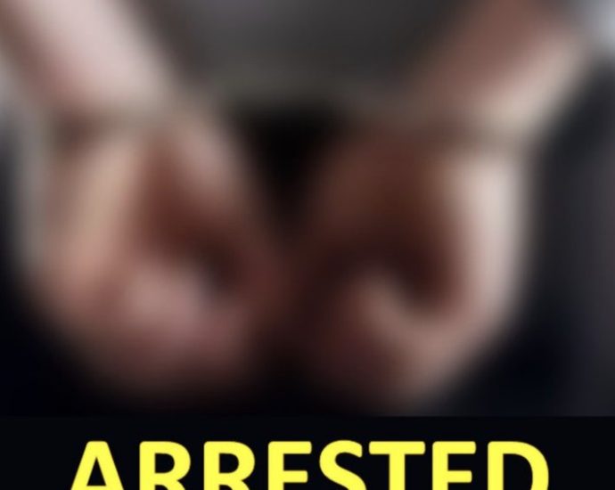 Burlington gun threats - Police officer making an arrest with handcuffs visible