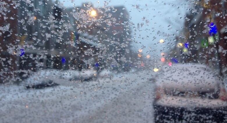 freezing drizzle waterloo - Icy road conditions with freezing rain coating pavement and vehicles