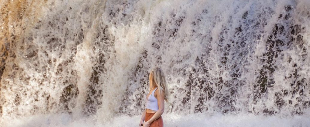 Hamilton hiking trails - Person hiking on trail near Webster's Falls in Hamilton with scenic waterfall view