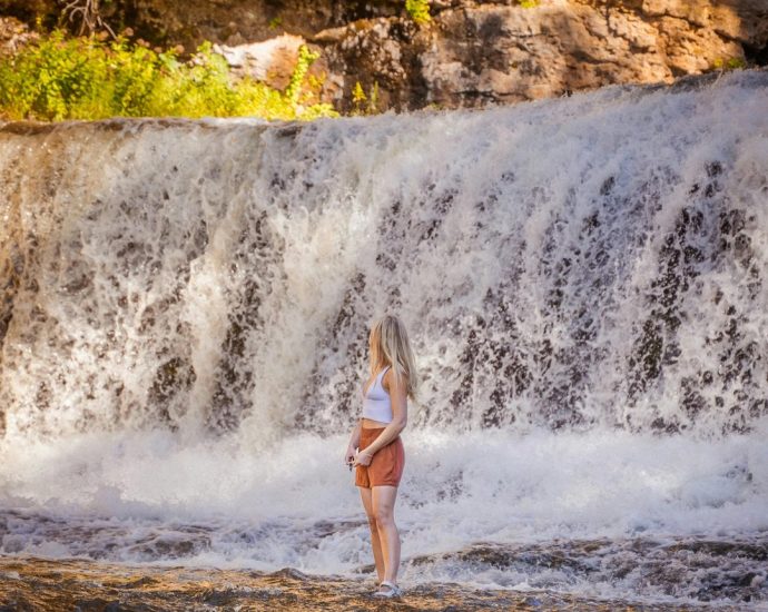 Hamilton hiking trails - Person hiking on trail near Webster's Falls in Hamilton with scenic waterfall view