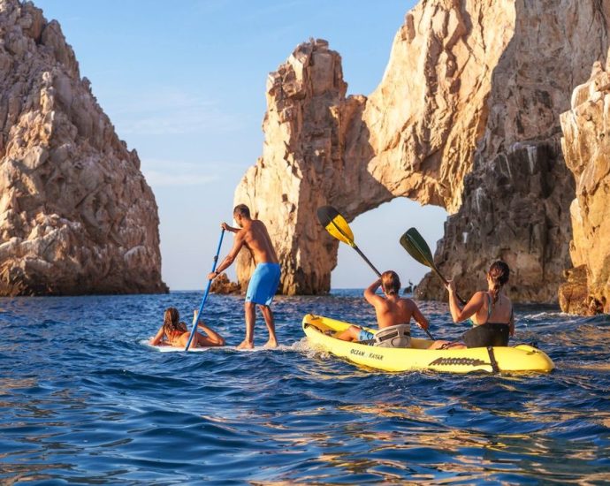 Los Cabos flights - Scenic view of Los Cabos beach with clear blue water and rocky formations