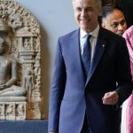 Mark Carney India - Mark Carney speaking at a business conference podium