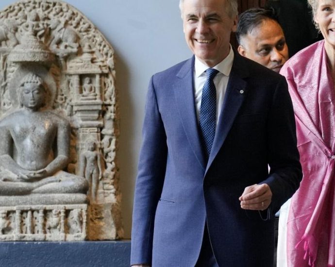Mark Carney India - Mark Carney speaking at a business conference podium