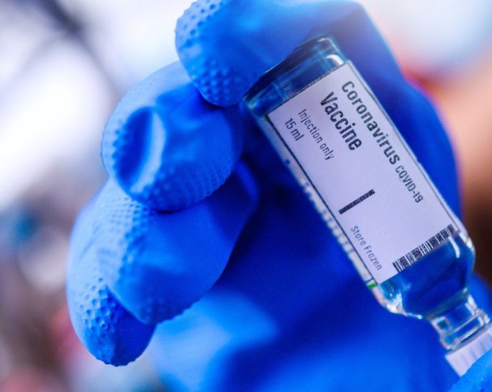 mRNA vaccine questions - Medical researcher working with mRNA vaccine samples in laboratory setting