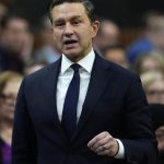 Poilievre Carney cooperation - Conservative leader Pierre Poilievre speaking at a podium during a political event