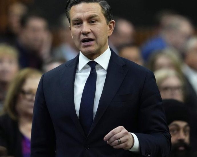 Poilievre Carney cooperation - Conservative leader Pierre Poilievre speaking at a podium during a political event