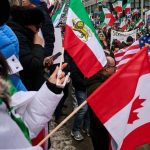Richmond Hill Iranian march - Crowd of protesters marching with Iranian flags and solidarity signs