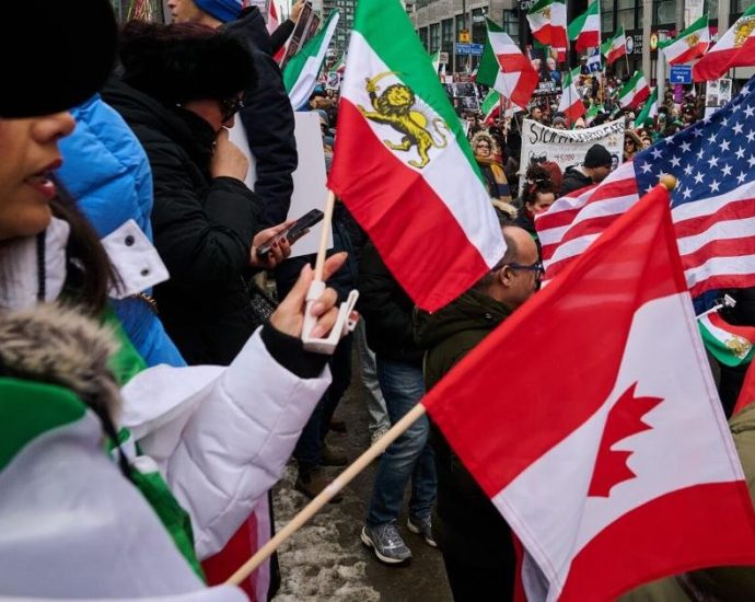 Richmond Hill Iranian march - Crowd of protesters marching with Iranian flags and solidarity signs