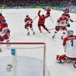 Team Canada Czechia game - Team Canada hockey players celebrating on ice after victory