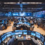 tech stocks rally - Stock market trading screens showing green numbers and upward trending charts