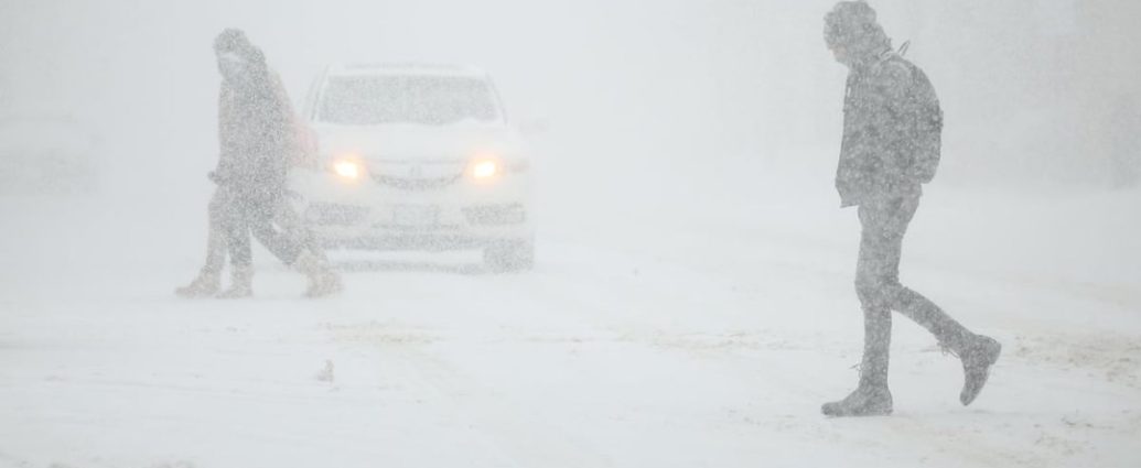 Snowy road conditions during Toronto winter storm with heavy traffic and poor visibility