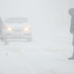 Snowy road conditions during Toronto winter storm with heavy traffic and poor visibility