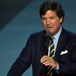 Tucker Carlson detained Israel - Tucker Carlson at an airport terminal with luggage and security personnel in background
