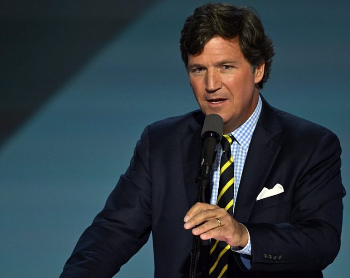 Tucker Carlson detained Israel - Tucker Carlson at an airport terminal with luggage and security personnel in background