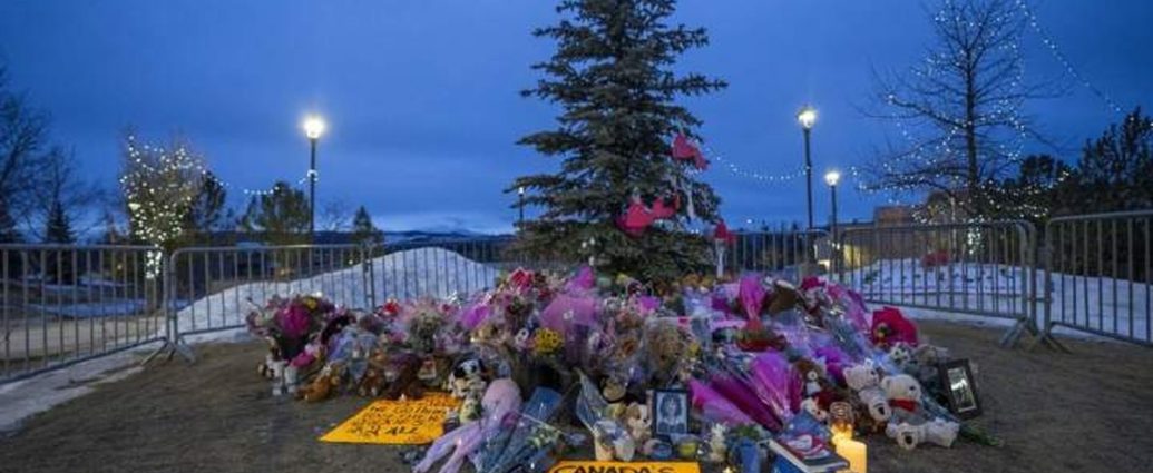Tumbler Ridge funeral cancelled - Memorial flowers and candles at a funeral service
