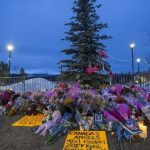 Tumbler Ridge funeral cancelled - Memorial flowers and candles at a funeral service