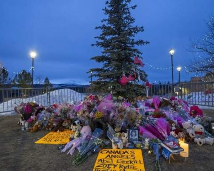 Tumbler Ridge funeral cancelled - Memorial flowers and candles at a funeral service