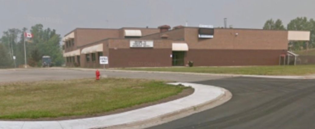 Tumbler Ridge shooting - Police vehicles and emergency responders at a school during an active investigation