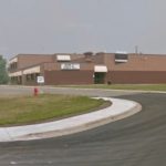 Tumbler Ridge shooting - Police vehicles and emergency responders at a school during an active investigation