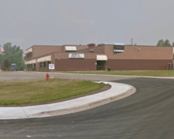 Tumbler Ridge shooting - Police vehicles and emergency responders at a school during an active investigation