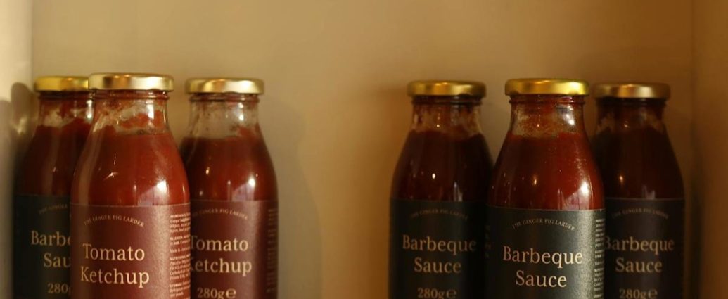 BBQ sauce recall - Glass bottle of BBQ sauce with orange label on kitchen counter