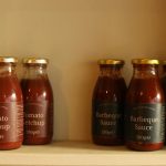 BBQ sauce recall - Glass bottle of BBQ sauce with orange label on kitchen counter