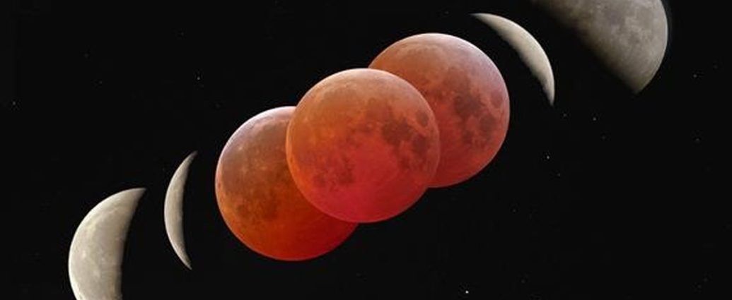 blood moon eclipse Canada - Red-tinted Moon during total lunar eclipse against dark sky