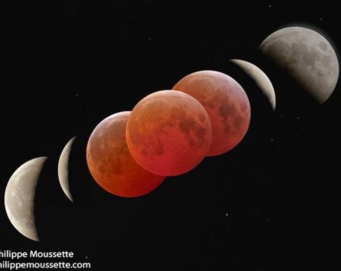 blood moon eclipse Canada - Red-tinted Moon during total lunar eclipse against dark sky