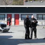 Burlington police shooting - Police vehicles and investigators at crime scene with yellow tape