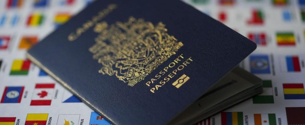 Canada travel warnings - Canadian passport on a world map highlighting Middle Eastern countries under travel advisory