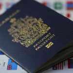 Canada travel warnings - Canadian passport on a world map highlighting Middle Eastern countries under travel advisory