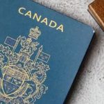 Canadian passport fees - Canadian passport and application documents on a desk