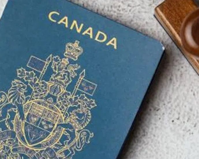 Canadian passport fees - Canadian passport and application documents on a desk
