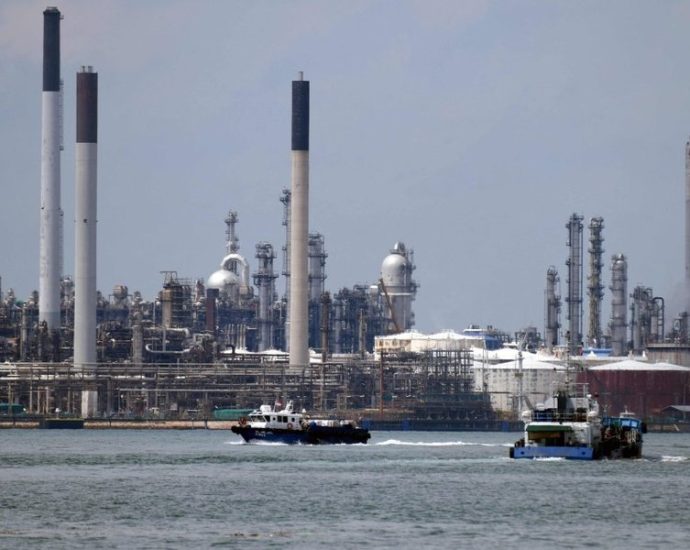 gas prices spike - Gas pump display showing rising fuel prices amid Middle East conflict