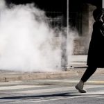 GTHA wind chill warning - Person bundled up walking in extreme cold weather with visible breath in winter conditions