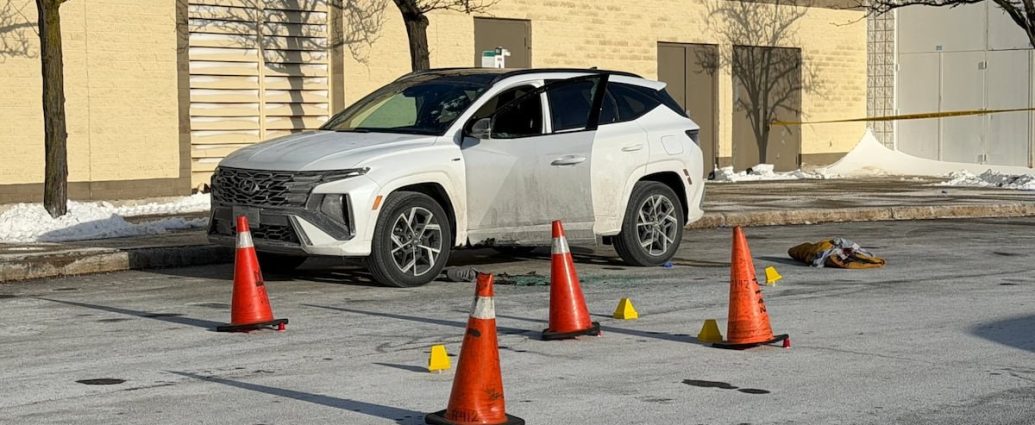Toronto police shootings - Police officers investigating a crime scene with evidence markers