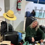 WestJet Puerto Vallarta - Passengers waiting at airport departure gate with luggage