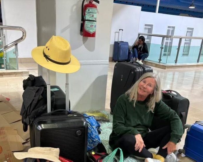 WestJet Puerto Vallarta - Passengers waiting at airport departure gate with luggage